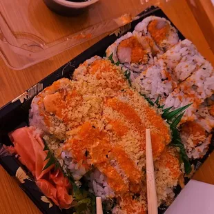a plate of sushi and chopsticks