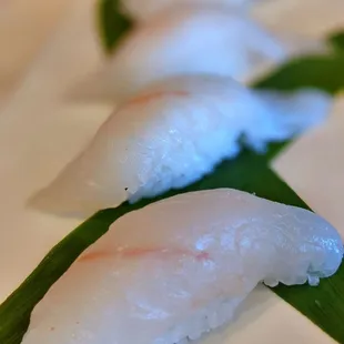 three pieces of sushi on a white plate