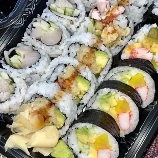 a tray of sushi and rolls