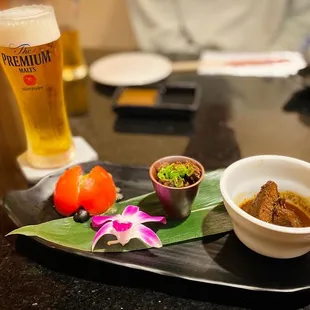 a plate of food and a glass of beer