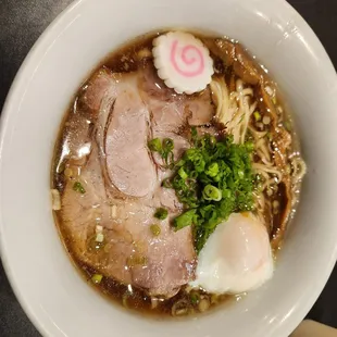 a bowl of soup with meat and noodles