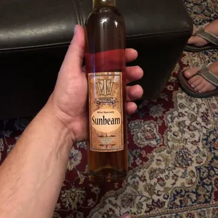 a person holding a bottle of sunbeam