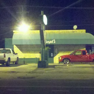 a red truck parked in front of a restaurant