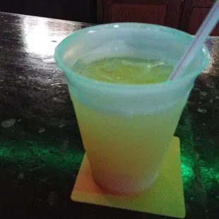 a drink in a plastic cup with a straw