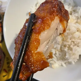 a bowl of rice and chopsticks