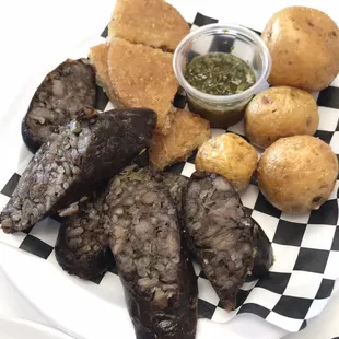 Morcilla with papas criolla and fried arepas