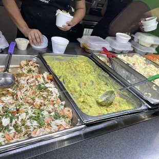 a woman preparing food at a buffet
