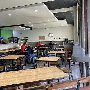 people sitting at tables in a restaurant