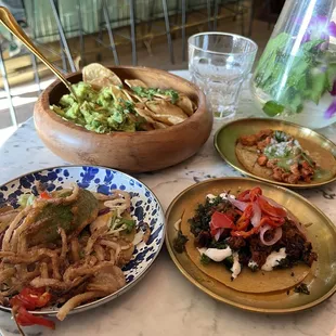 Guacamole with chips, fried avocado taco, eggplant soyrizo, and chicken Al pastor