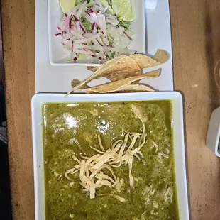 Pozole Verde, chips and toppings of radishes, lettuce and limes