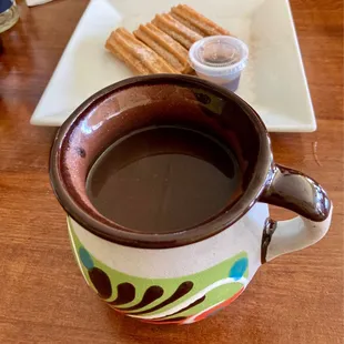 Café de olla and churros  with chocolate fudge.