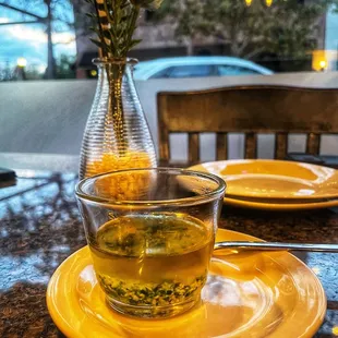 a cup of green tea on a table