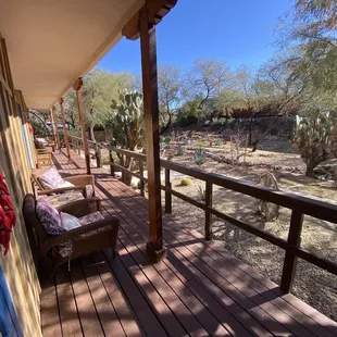 Nice deck and comfy chairs in front of three lower level rooms.