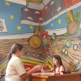 Nieces at the drawing table, upstairs in the kids area