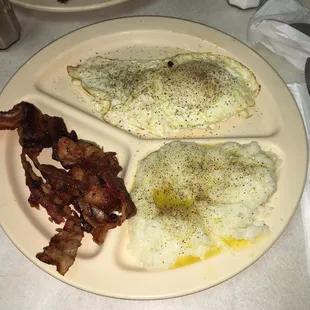 My breakfast I ordered. Two eggs with bacon and a hot cake. Looks so delicious
