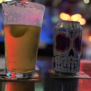 a glass of beer and a can of beer