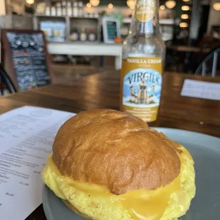 Sausage, egg and cheese sandwich on brioche bun.
