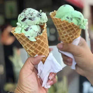 two people holding ice cream cones