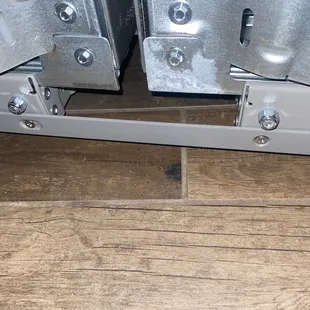 Photo is stripped screws, sheared leveler, and brackets not installed.