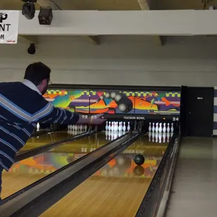 a man throwing a bowling ball