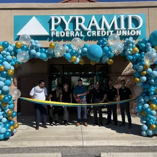 Ribbon cutting ceremony with color matching balloons and Marquee letters.
