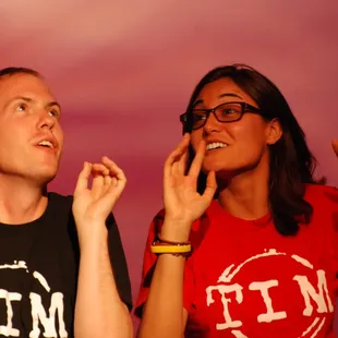 a man and a woman with their hands in the air