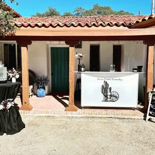 Bar setup including water station and sign for guests.