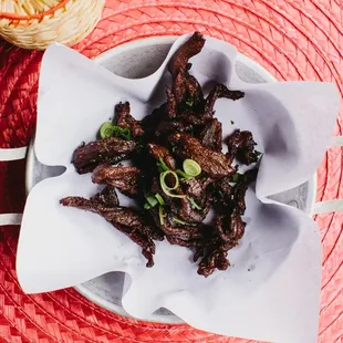 Northeastern Thai beef jerky with coriander served with sticky rice