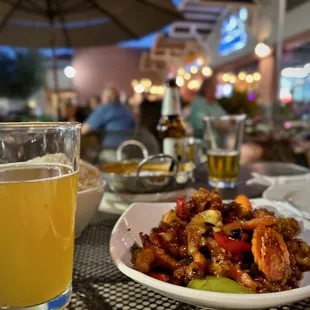 a plate of food and a glass of beer
