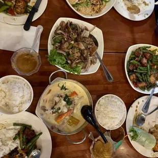 A table full of plates to share!   Pork and green beans, summer rolls, pumpkin curry (10/10), pad Thai, and a pork dish (#23)