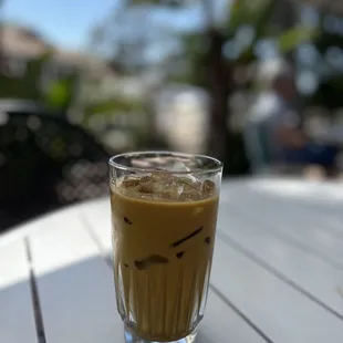 a glass of coffee on a table