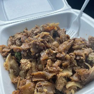 a close up of a food dish in a styrofoam container