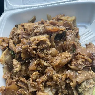 a plate of food in a styrofoam container