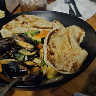 Prik Pow Mussels Medium spicy mussels in spicy garlic roasted chili paste, jalapeno, basil, and red bell. Serve with 2 Roti $18.50+