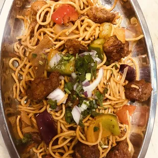 a bowl of noodles with meat and vegetables