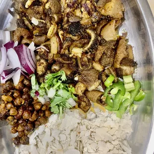 a bowl of rice, meat, and vegetables