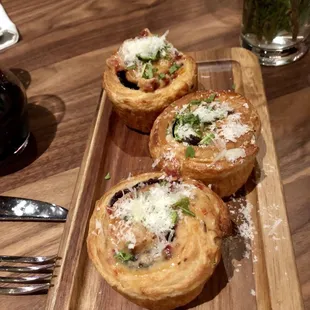 three pastries on a wooden tray