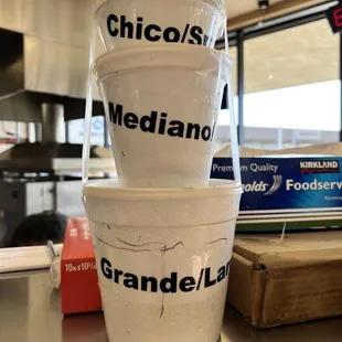 a stack of three cups on a counter