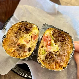 two burritos wrapped in foil