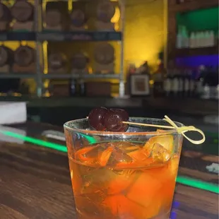 an orange drink with a garnish garnish