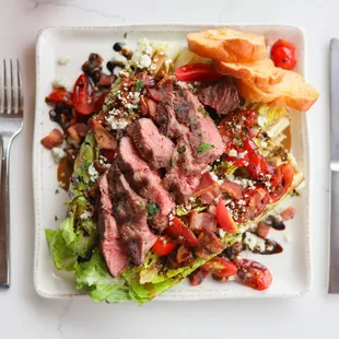 a plate of steak and salad