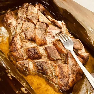Mojo pork wrapped in banana leaves for the Conyo.