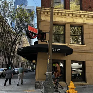 a yellow fire hydrant in front of a building