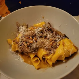 a plate of pasta with meat and cheese