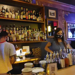 a man and a woman behind the bar