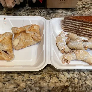 From left to right: Bishop hats, wonder kiflis and a slice of dobos torte.