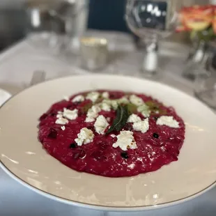 a plate of beetroot soup with feta cheese