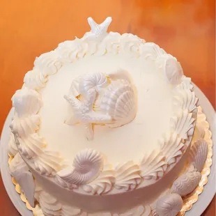 a white cake with shells on top