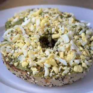 Avacado toast bagel with grated hard-boiled egg and everything bagel seasoning