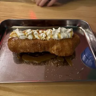 The churro, with caramel filling and topped with whipped cream.